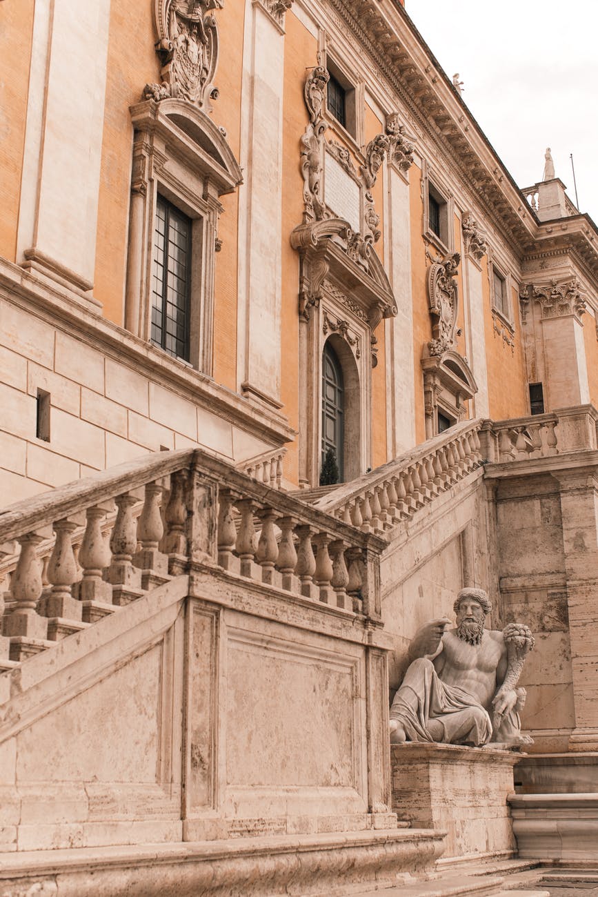 facade of old stone building with sculpture WHY DOES YOUR HOUSE CLADDING MATTER?