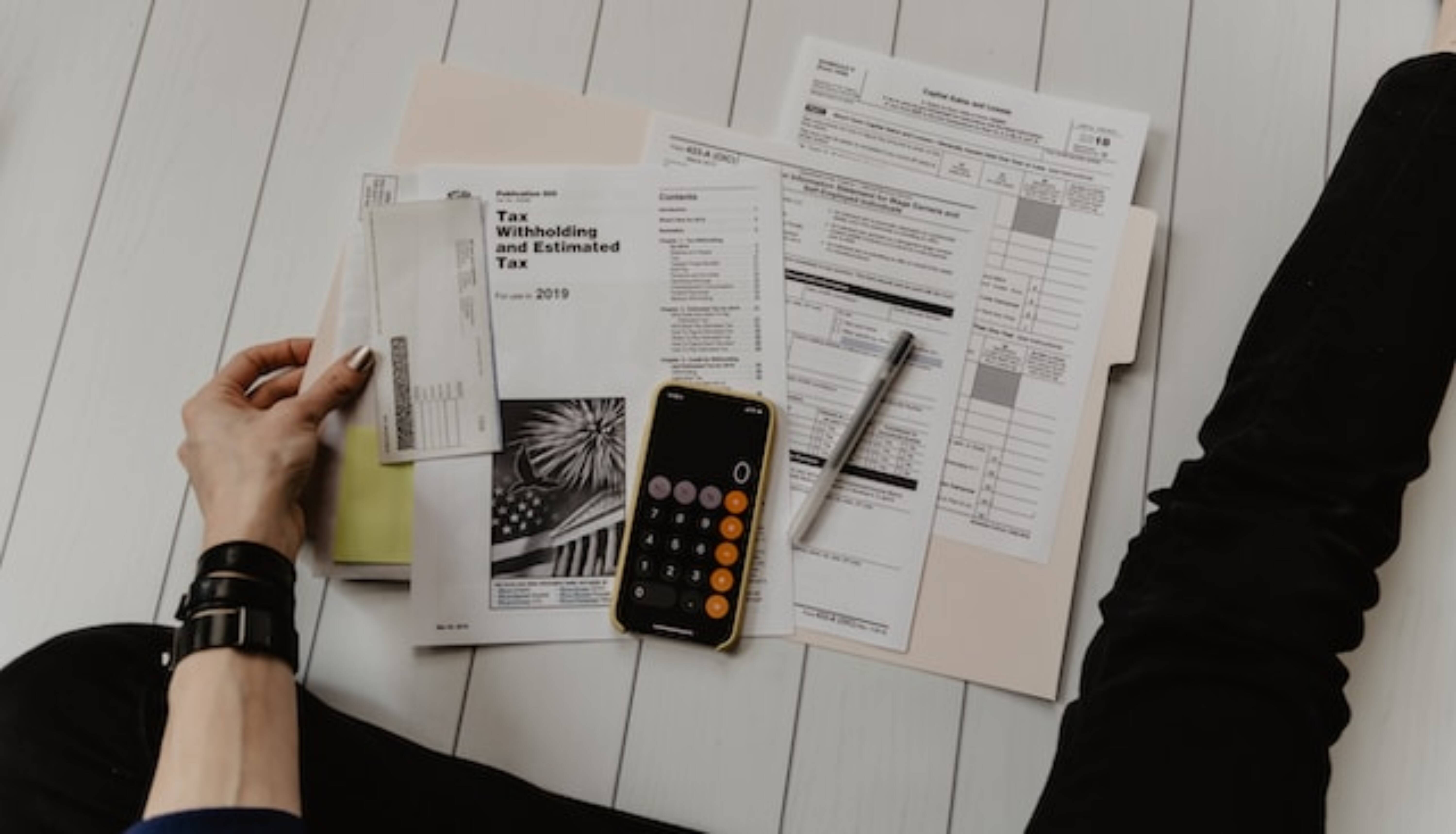 Person sitting on the floor and analyzing local tax assessment records