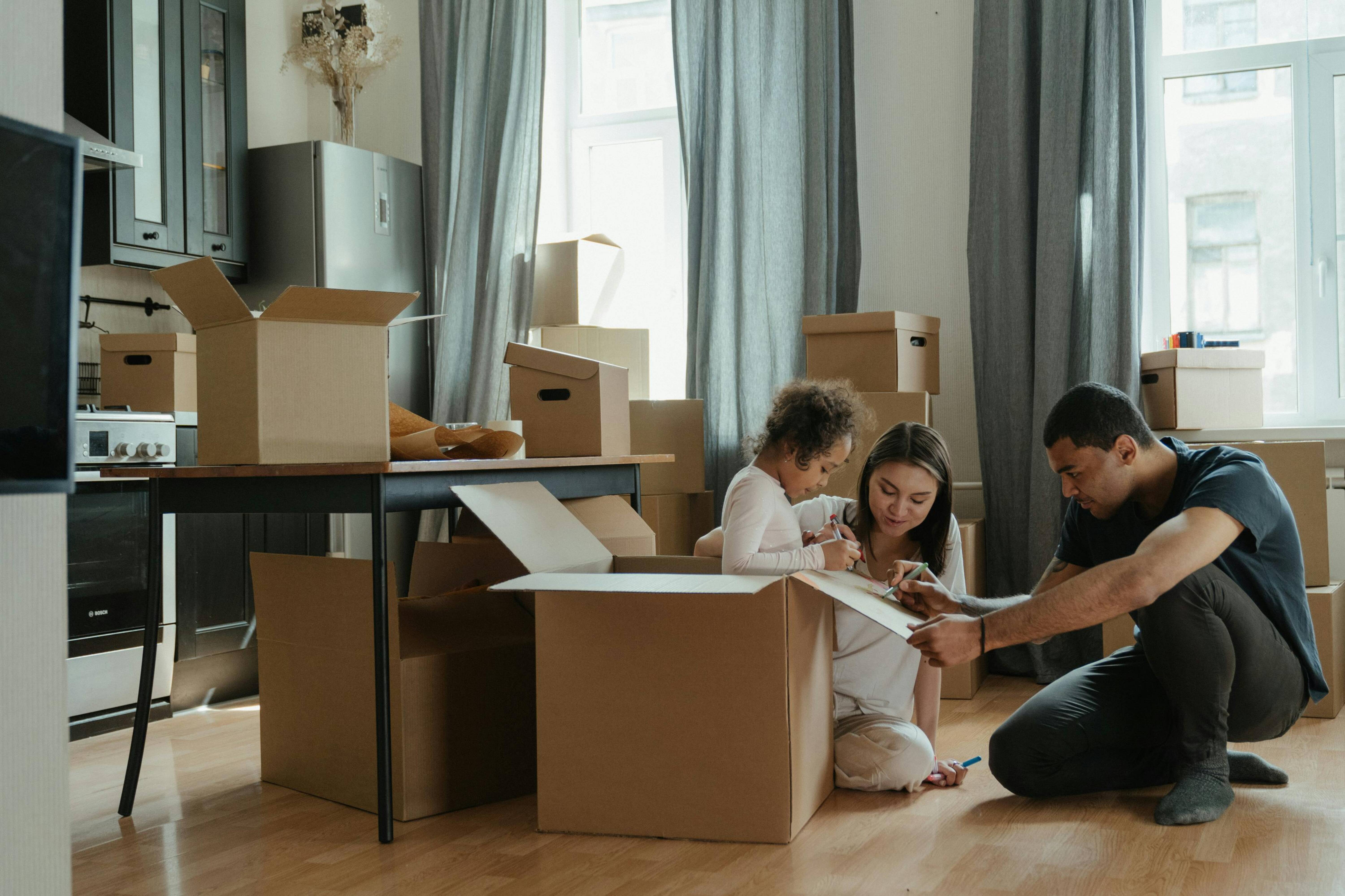 A family unpacking boxes in a room