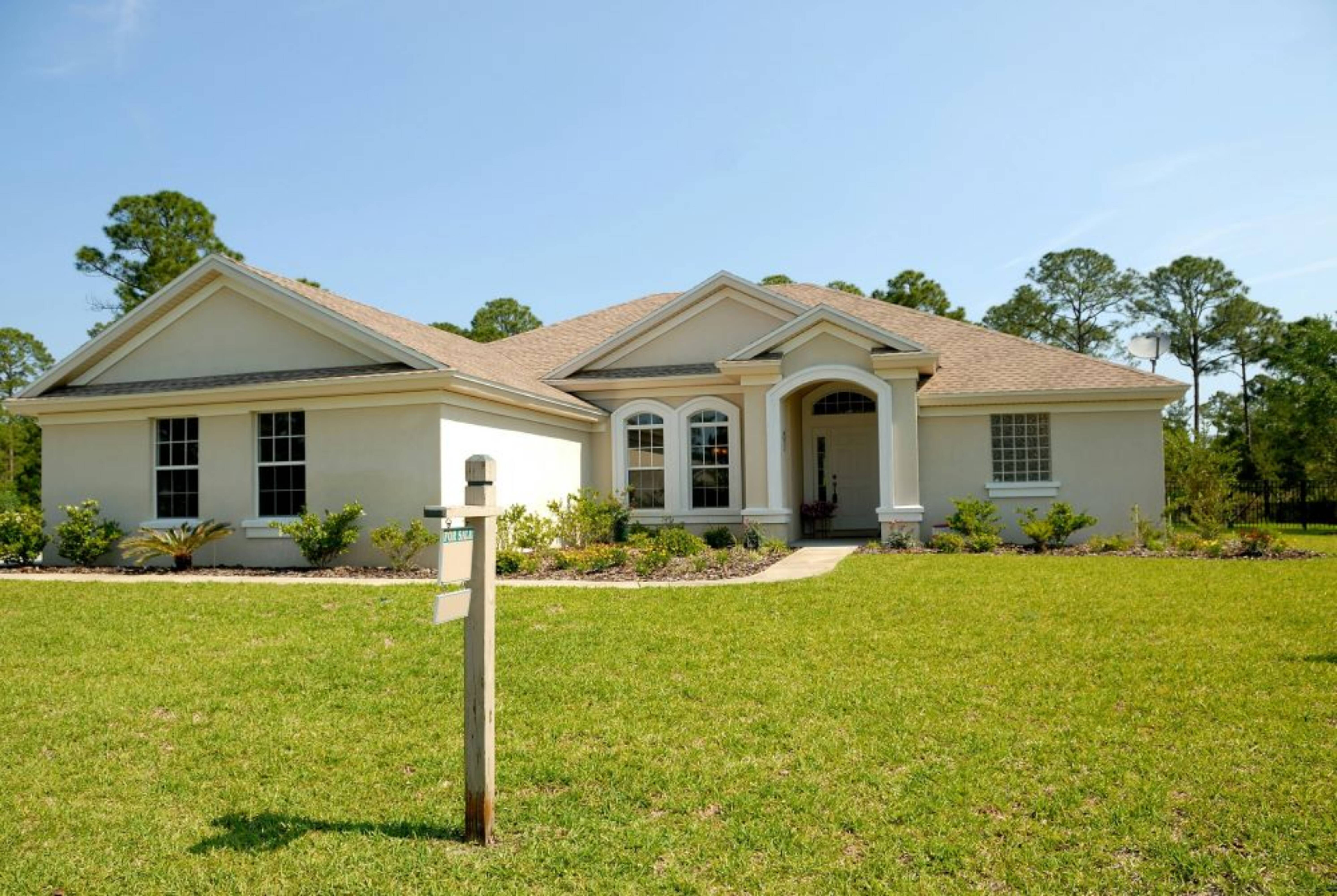 A white house with a yard.